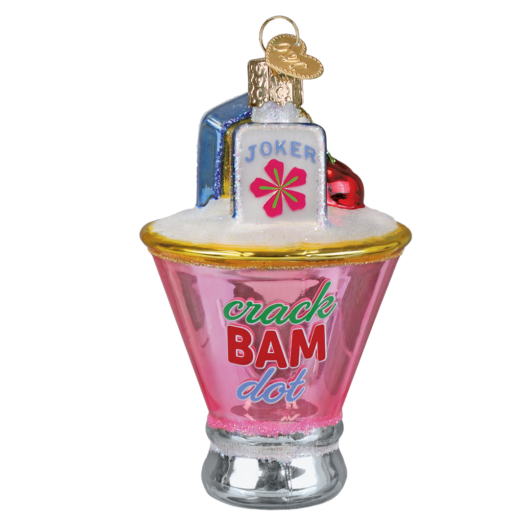 Pink martini glass ornament with a Joker mahjong tile, cherry, and Crack Bam Dot lettering, front view on white