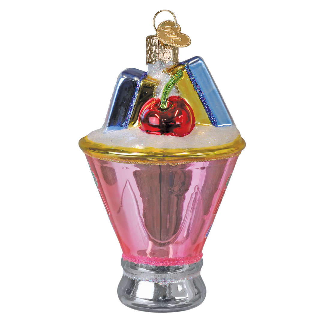 Back of the mahjong martini ornament with a red cherry and stacked tiles above the pink glass