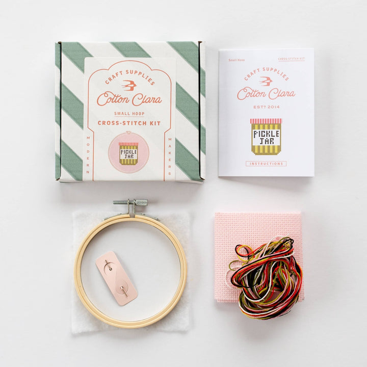 Pickle jar cross stitch kit contents with hoop, pink aida, needle, and thread