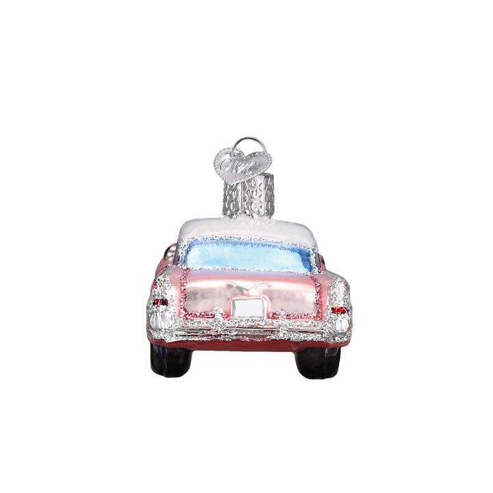 Rear view of the pink classic car ornament with red taillights and tail fins, on white