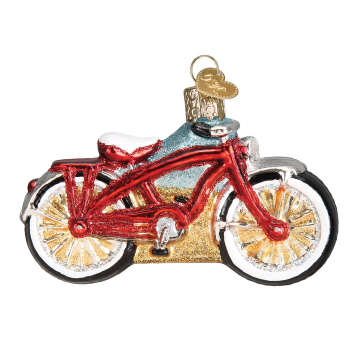 Red cruiser bike ornament side view with whitewall tires, gold spokes, and white seat, on white
