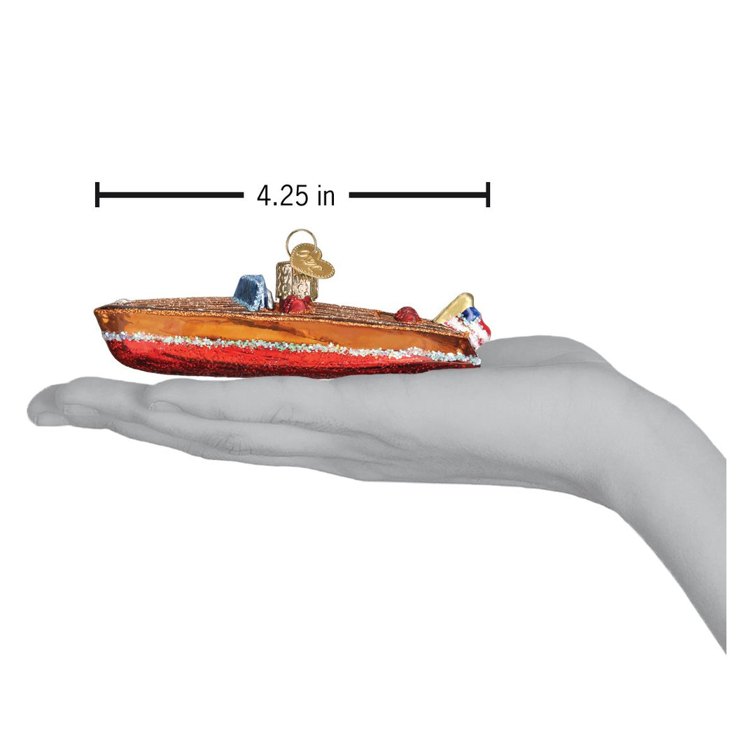 Wooden boat ornament resting on an open palm under a 4.25 inch length marker