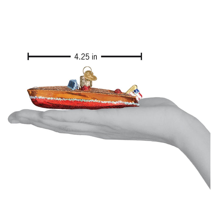 Wooden boat ornament resting on an open palm under a 4.25 inch length marker