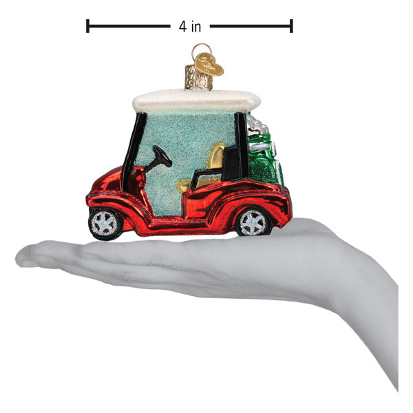 Golf cart ornament on an open hand with a 4 inch scale marker above it