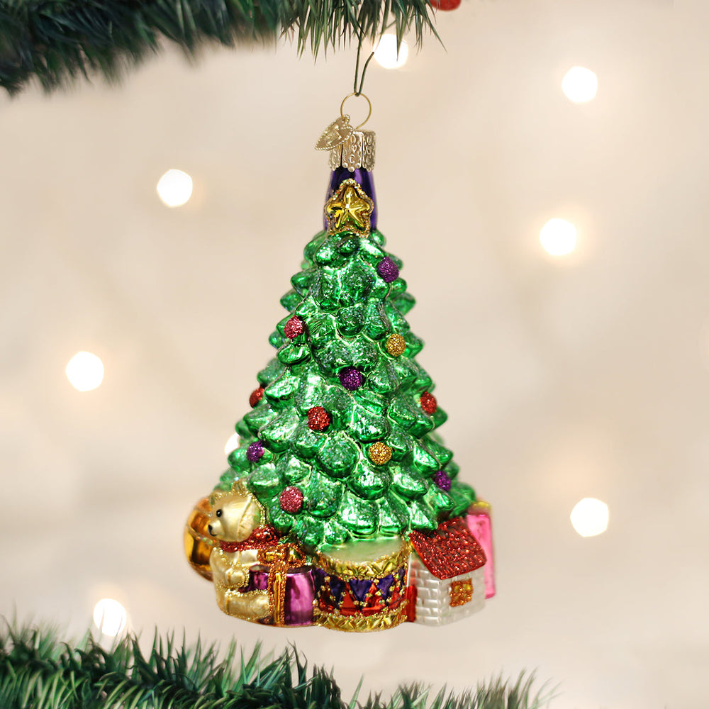Christmas morning tree glass ornament hanging on a lit Christmas tree