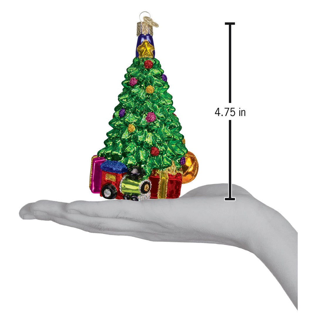 Christmas morning tree ornament on an open palm beside a 4.75 inch height marker