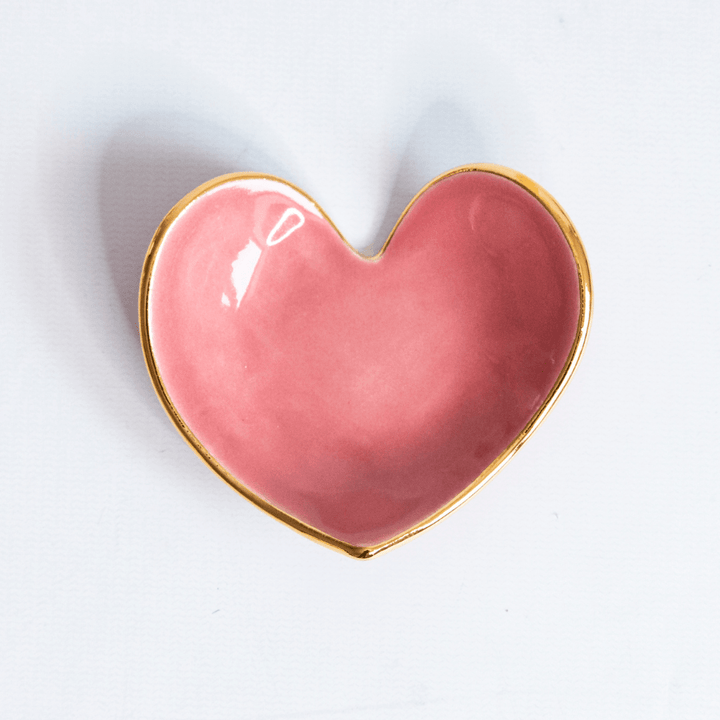Close view of a rose pink heart ring dish with a gold rim