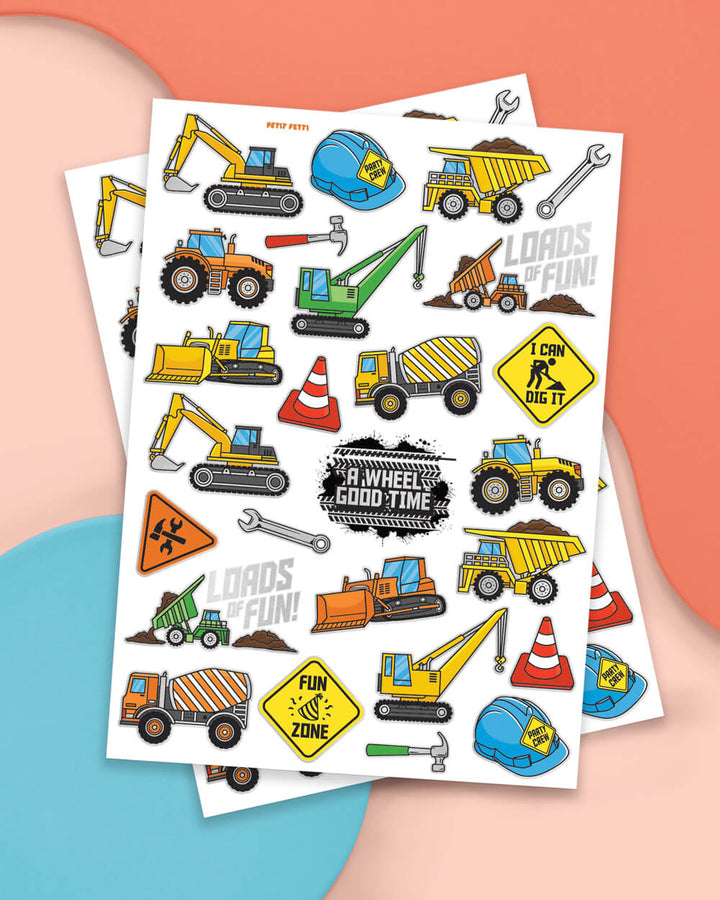 Two sheets of construction temporary tattoos with excavators, cement mixers, cones, and signs