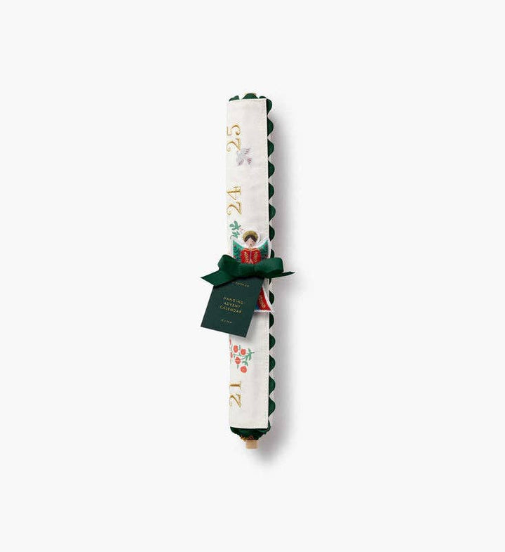 Nativity advent calendar rolled on its wooden dowel with green ribbon and gift tag for keepsake gifting