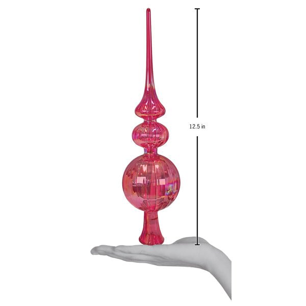 Pink glass tree topper on an open palm beside a 12.5 inch height marker