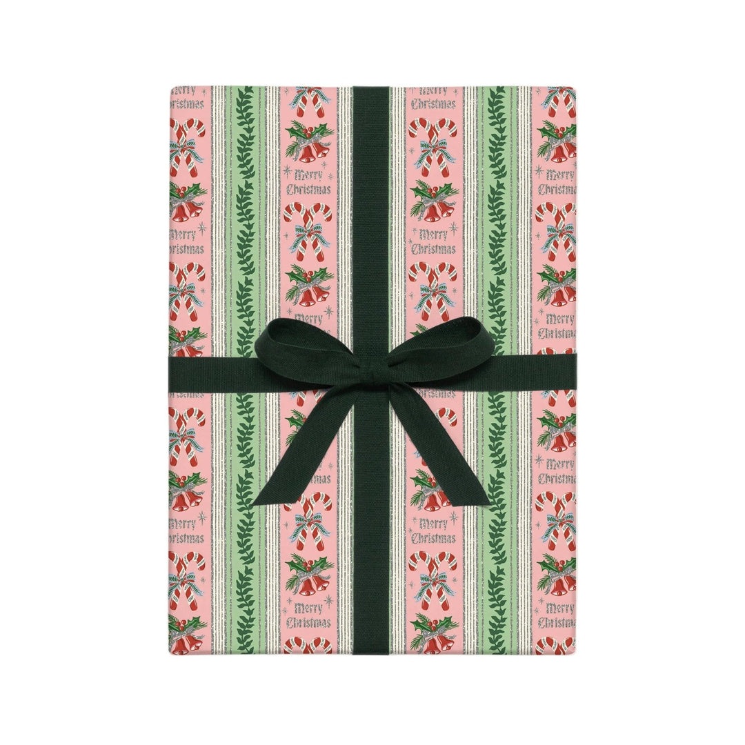 Candy cane stripe Christmas wrapping paper in pink and green with vintage Merry Christmas lettering on a wrapped box