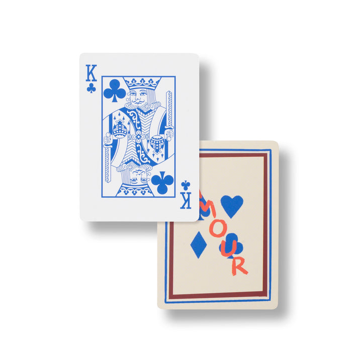King of clubs in blue line art beside the cream Amour deck back, hand illustrated cards for card table gatherings