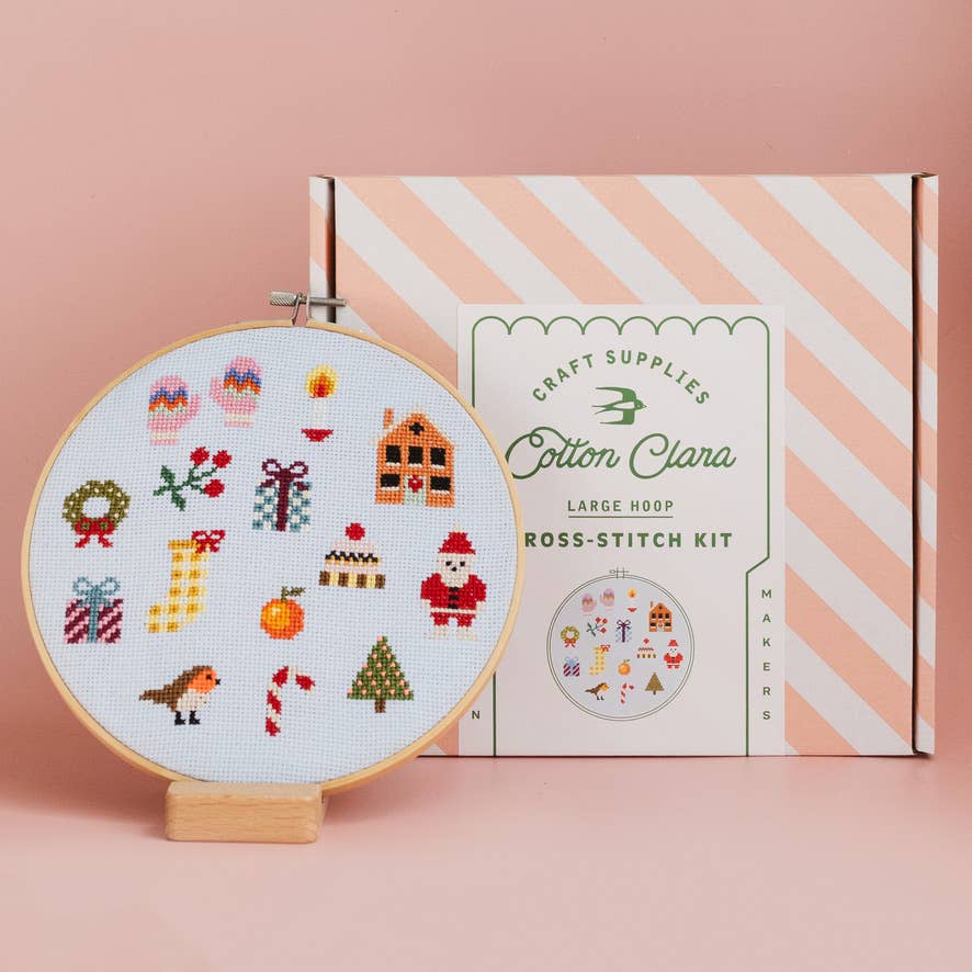 Christmas cross stitch sampler hoop beside Cotton Clara large hoop kit box
