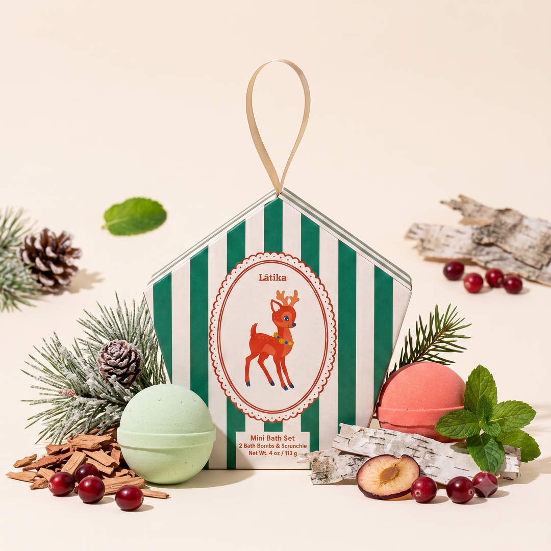 Baby deer bath set with pinecones, cranberries and mint styled around green and coral bath bombs for holiday gifting