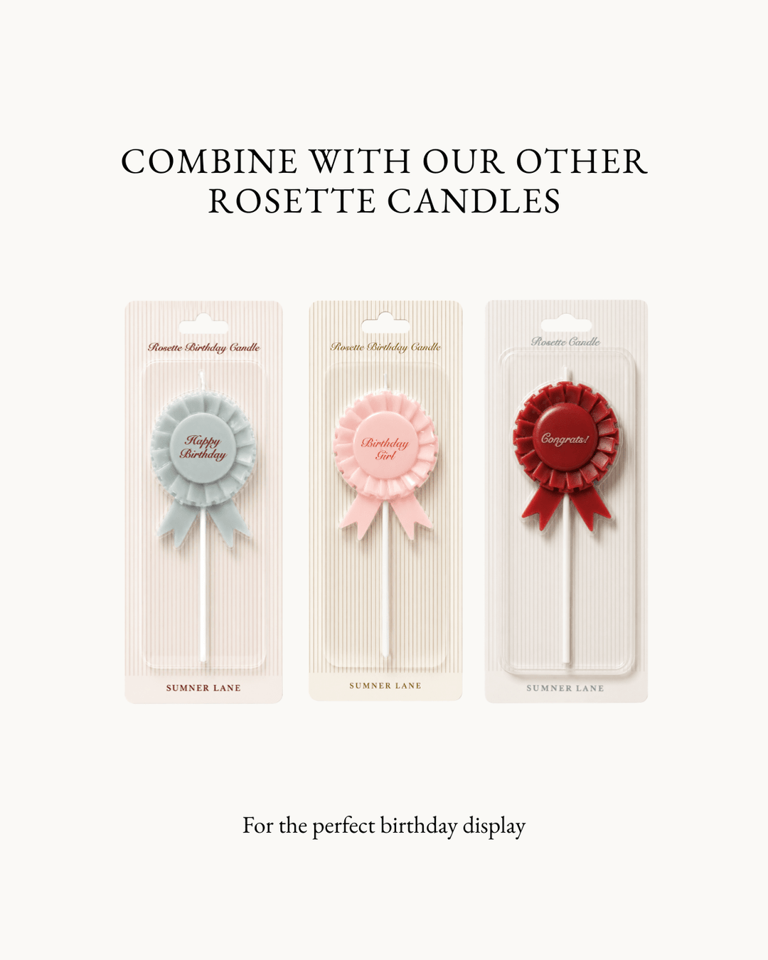 Three rosette-shaped candle sticks in pastel blue, pink, and deep red, each mounted on a clear display card with decorative ribbon details. The image includes text above reading 'COMBINE WITH OUR OTHER ROSETTE CANDLES' and below reading 'For the perfect birthday display' on a plain light background.