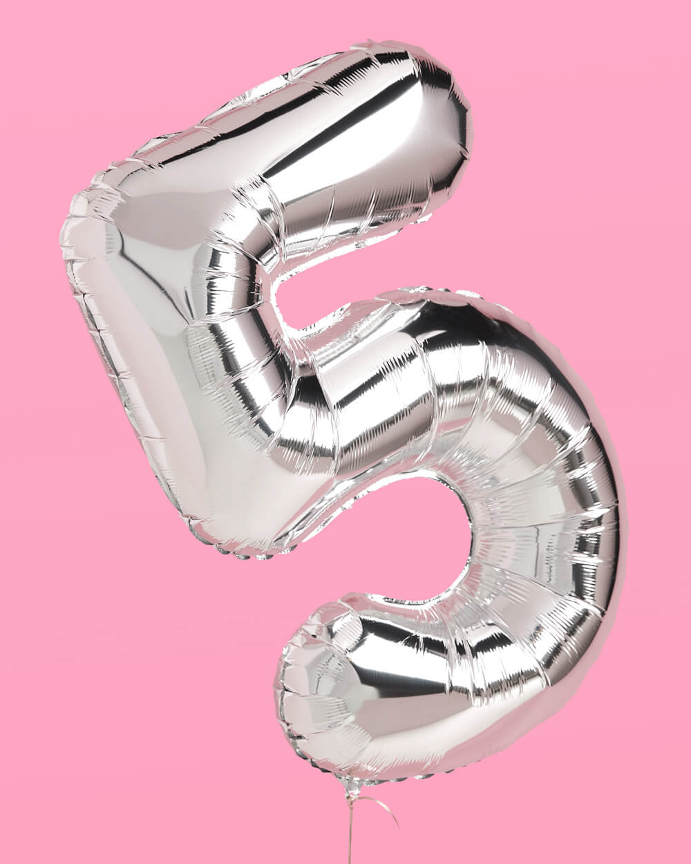 Silver 40 inch foil number 5 balloon against a pink background