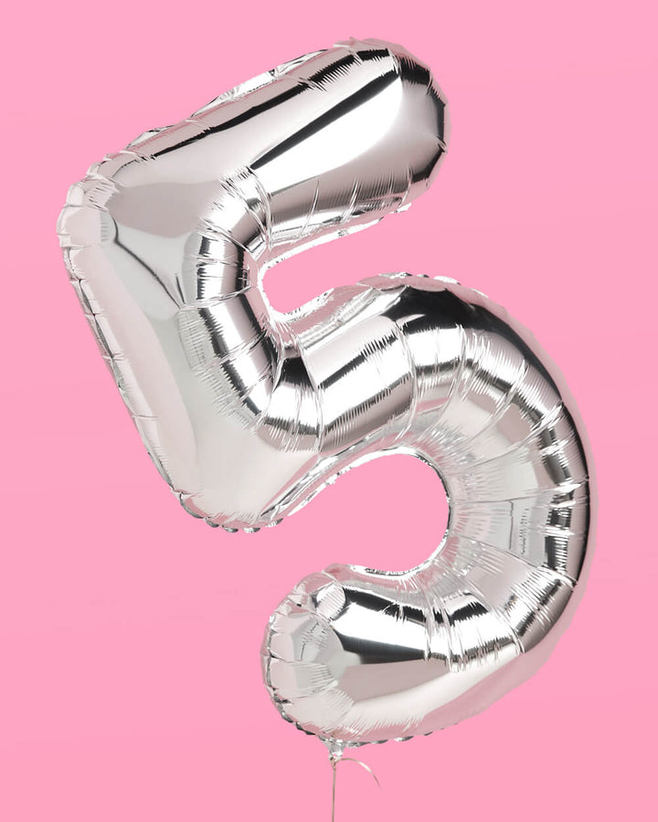 Silver 40 inch foil number 5 balloon against a pink background