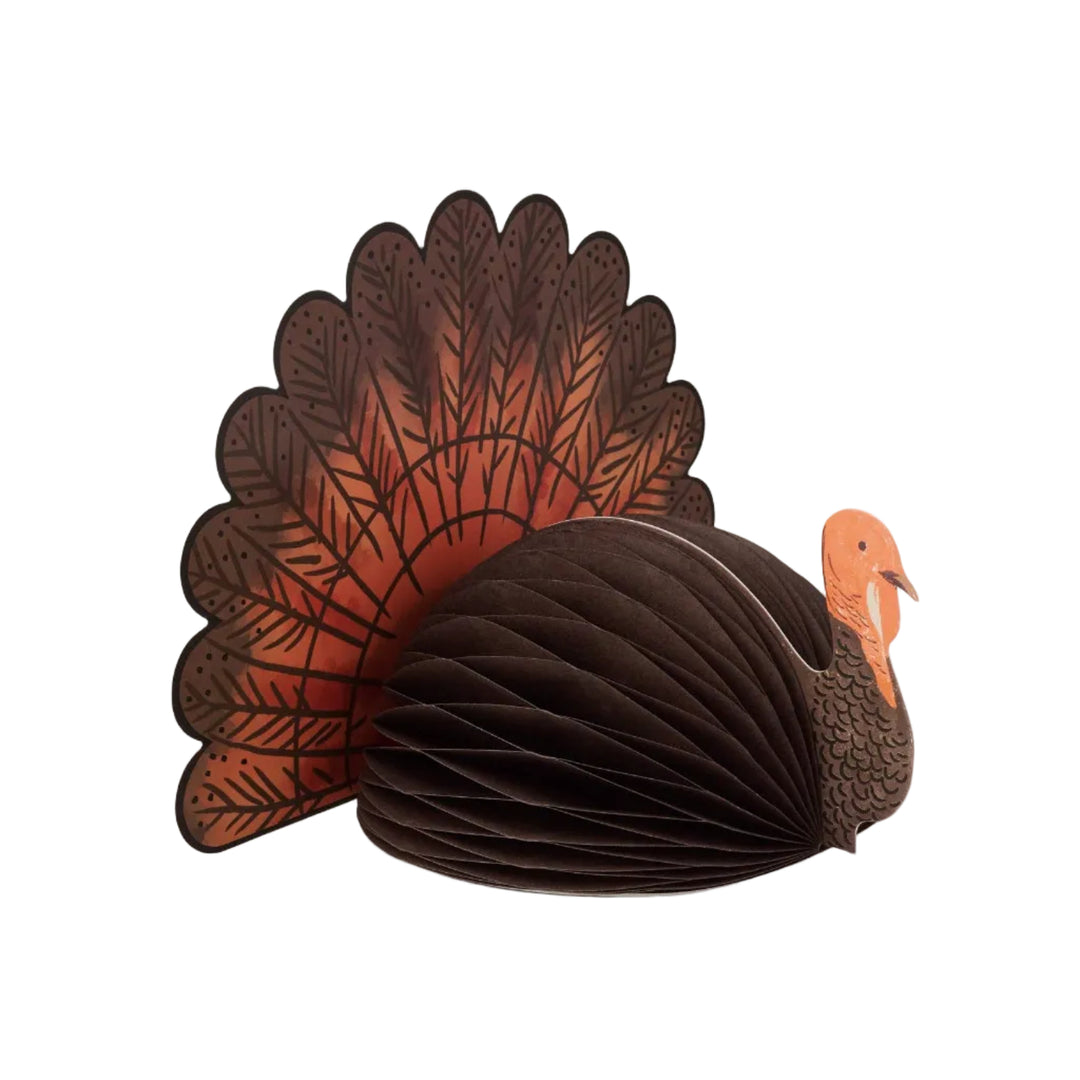 Honeycomb turkey centerpiece with dark brown paper body and rust illustrated tail feathers for the Thanksgiving table