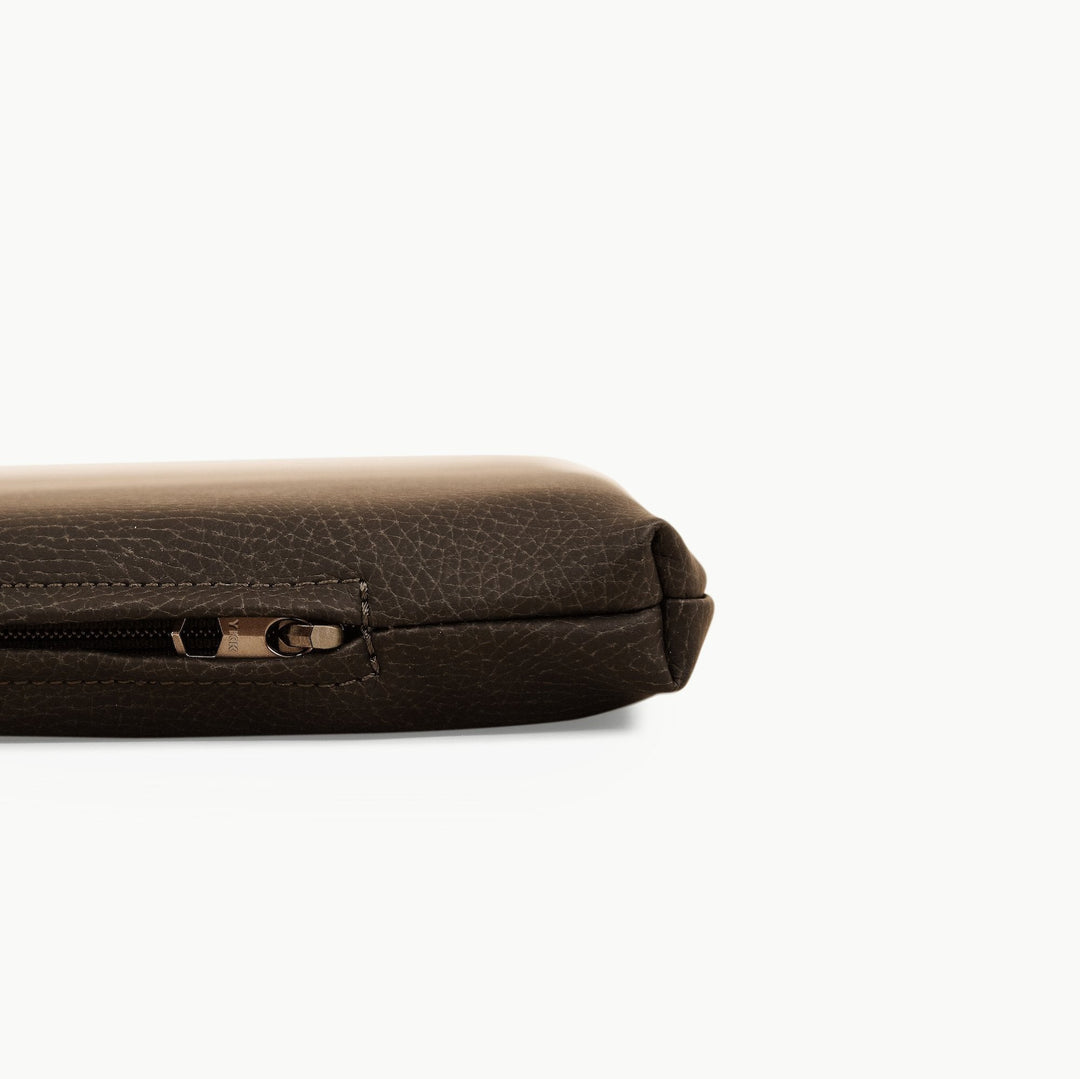 Close-up of the zippered edge on the espresso vegan leather padded play mat