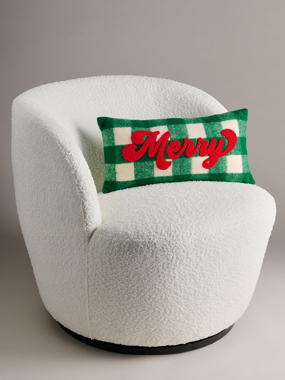 Green buffalo check Merry pillow on a white boucle chair