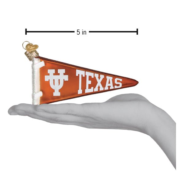 Texas pennant ornament resting on an open hand with a 5 inch length marker for scale