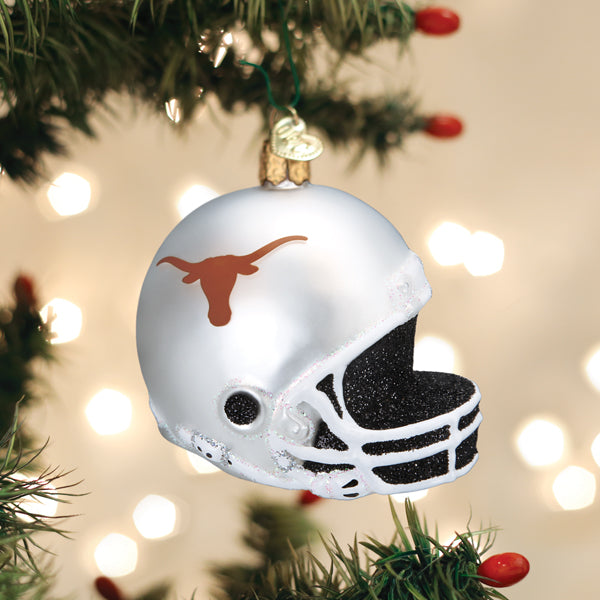 Texas Longhorns helmet Christmas ornament hanging on a pine tree with glowing lights