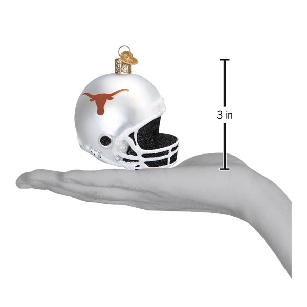 Texas Longhorns helmet ornament on an open hand with a 3 inch scale marker beside it