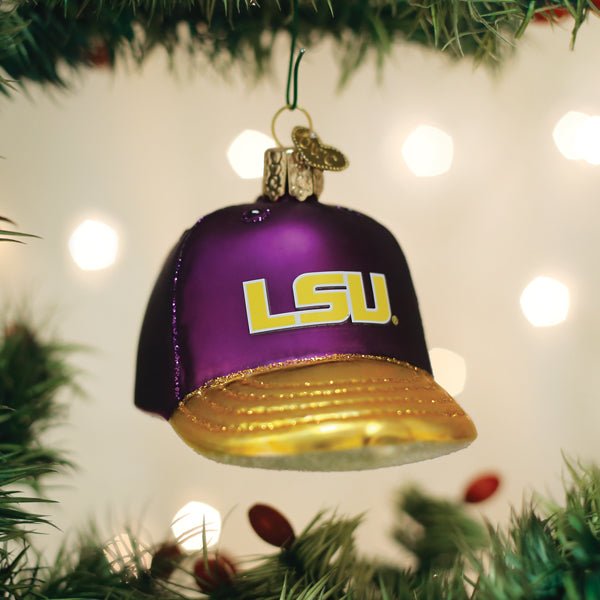 Purple and gold LSU Tigers cap ornament hanging on a Christmas tree with golden twinkle lights