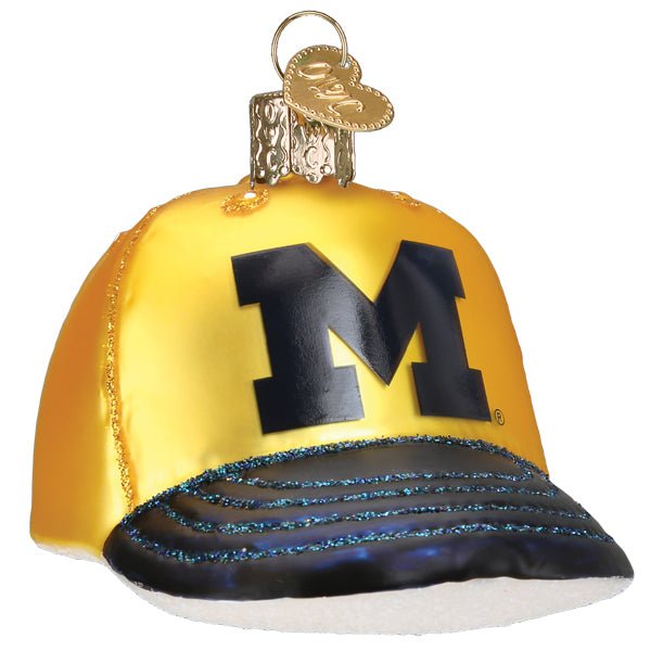Michigan baseball cap glass ornament, front view, maize crown with navy block M and navy brim on white