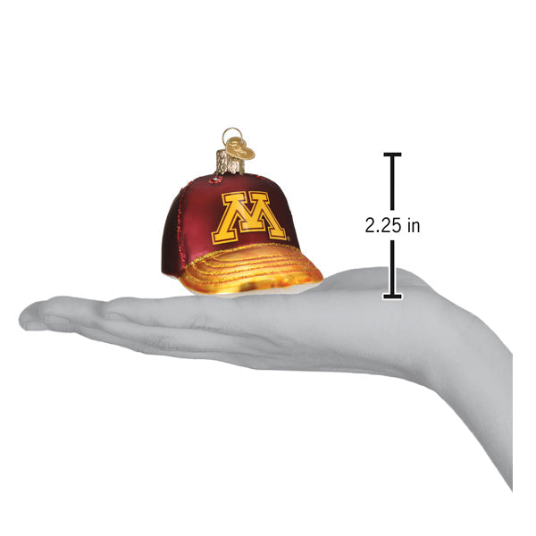 Minnesota cap ornament on an open palm beside a 2.25 inch height marker for scale