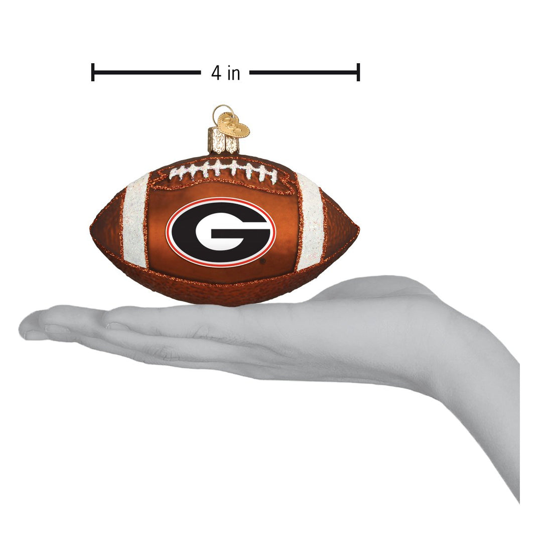 Georgia football ornament held in an open hand to show its size
