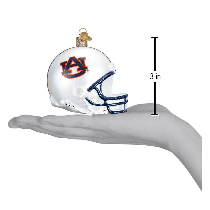 Auburn helmet ornament held in an open hand to show its size