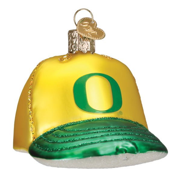 Oregon cap ornament, front three-quarter view with a green O logo on a yellow crown and glittered green brim, on white
