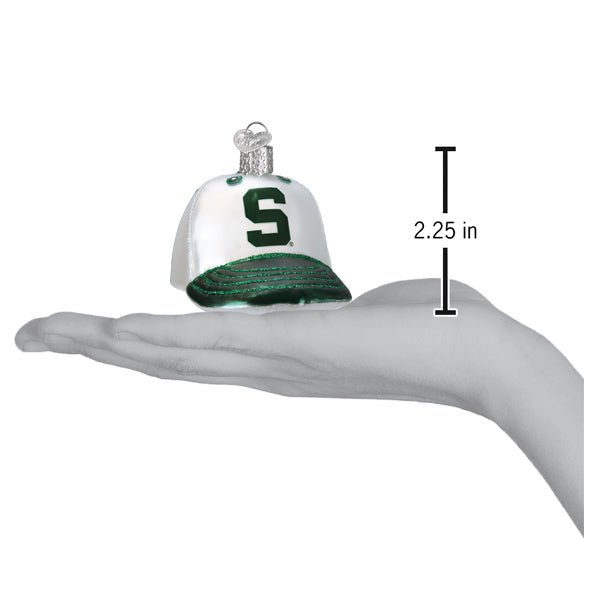 Michigan State cap ornament on an open palm beside a 2.25 inch height marker