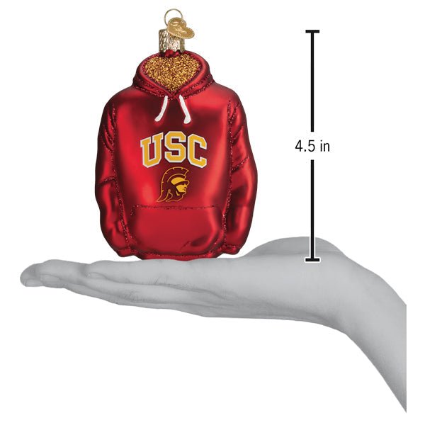 USC Trojans hoodie ornament on an open hand with a 4.5 inch scale marker beside it