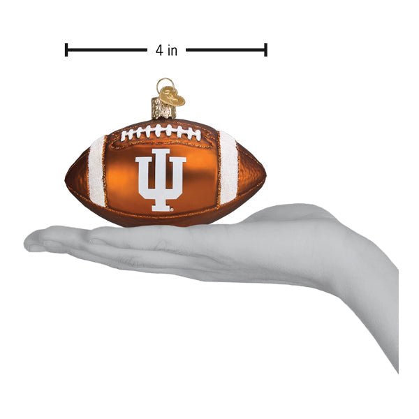 Indiana football ornament on an open palm beside a 4 inch width marker for scale
