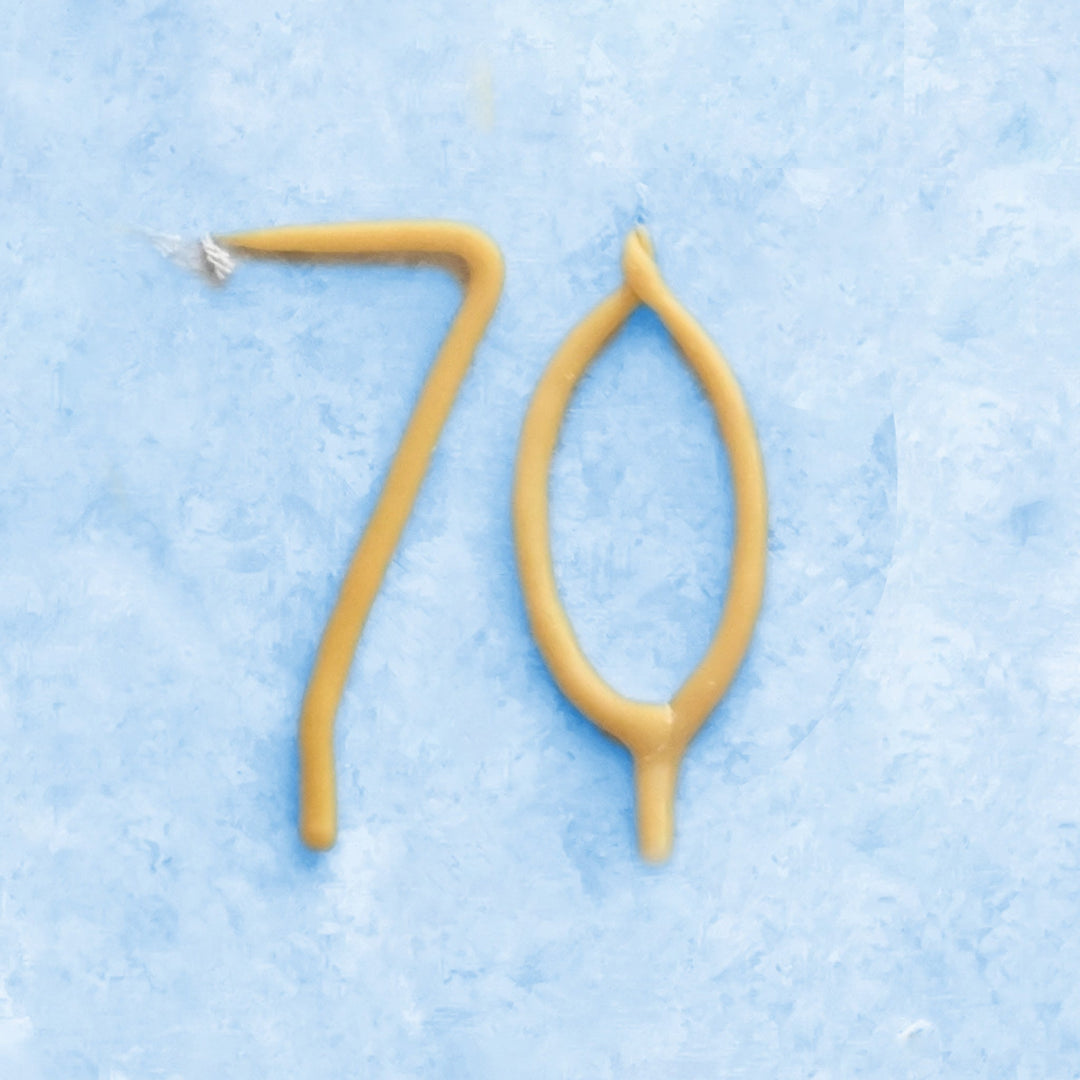 Beeswax number 70 birthday candles in natural honey color for a 70th birthday celebration