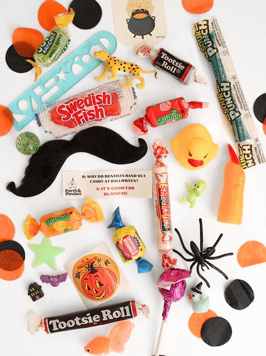 Spooky goodies from the black plaid jumbo bon bon: retro candy, toys, a Halloween joke card, and confetti for trick-or-treat