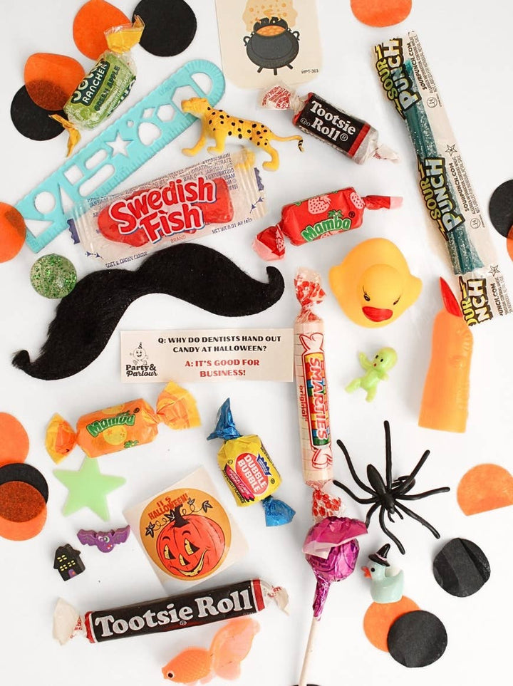 Spooky goodies from the black plaid jumbo bon bon: retro candy, toys, a Halloween joke card, and confetti for trick-or-treat