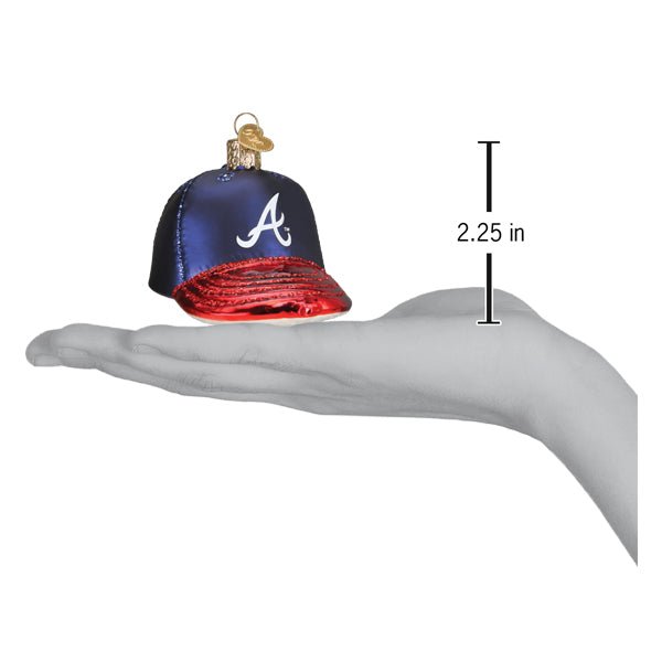 Braves baseball cap ornament resting on an open palm beside a 2.25 inch height marker
