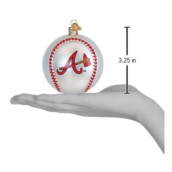 Braves baseball ornament resting on an open palm beside a 3.25 inch height marker