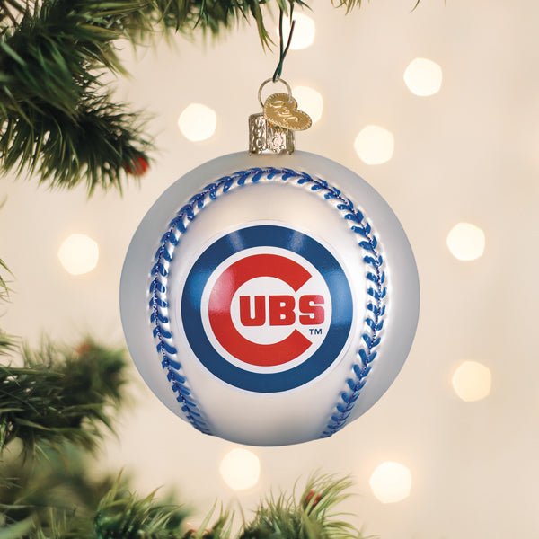 Chicago Cubs baseball ornament hanging on a lit Christmas tree with warm bokeh lights and pine branches