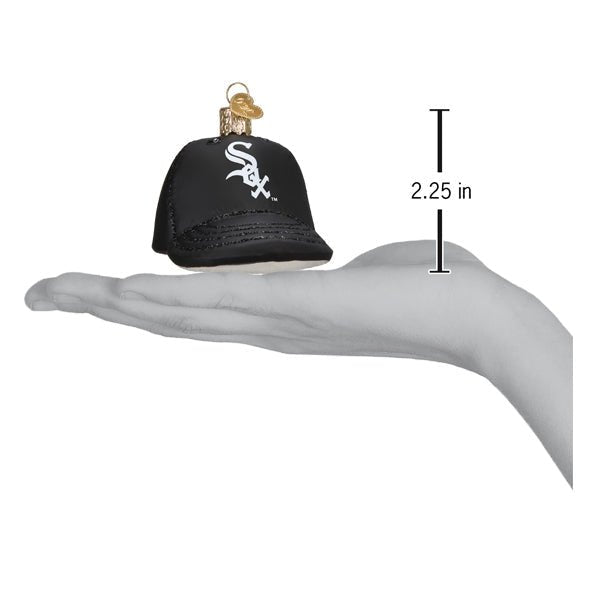 White Sox baseball cap ornament resting on an open palm beside a 2.25 inch height marker