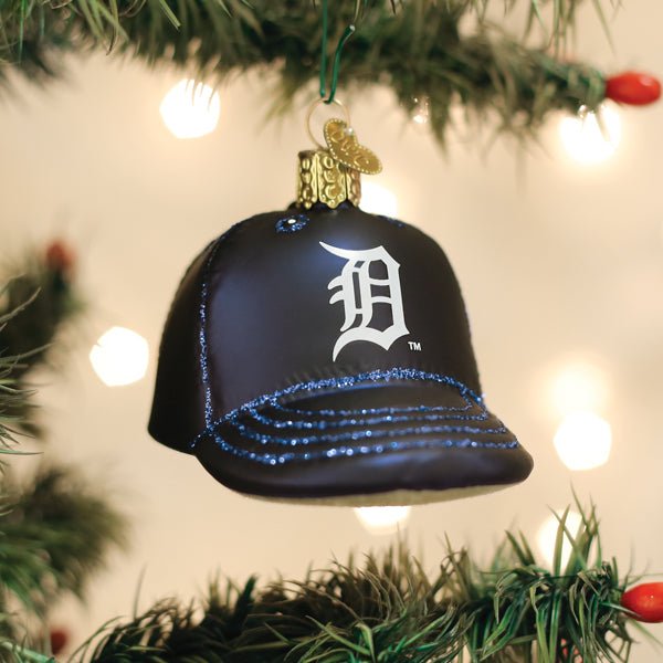 Tigers cap ornament hanging on a lit Christmas tree with warm glowing bokeh lights behind