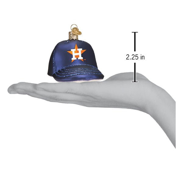 Astros baseball cap ornament resting on an open palm beside a 2.25 inch height marker