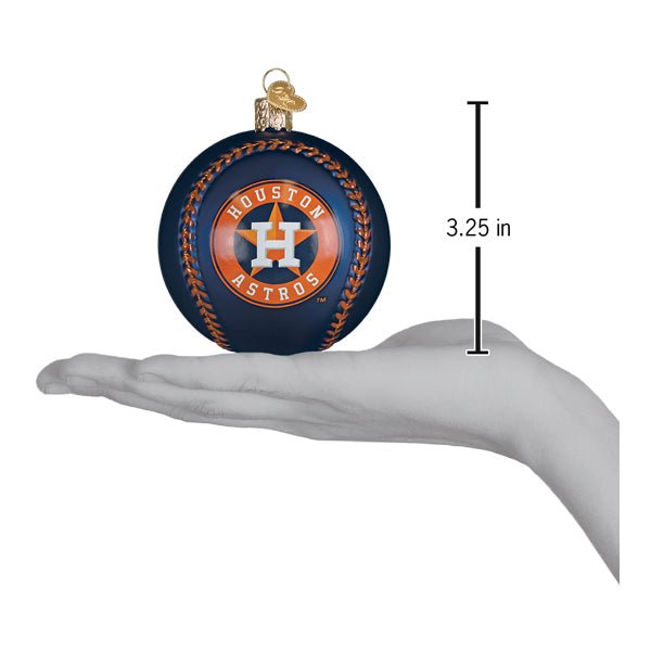 Astros baseball ornament resting on an open palm beside a 3.25 inch height marker