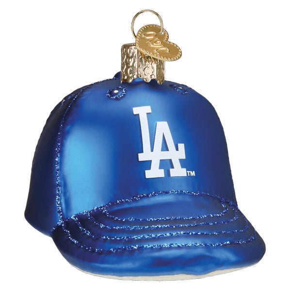 Front of the Los Angeles Dodgers cap ornament, a royal blue glass cap with the white LA logo and glittered brim, on white