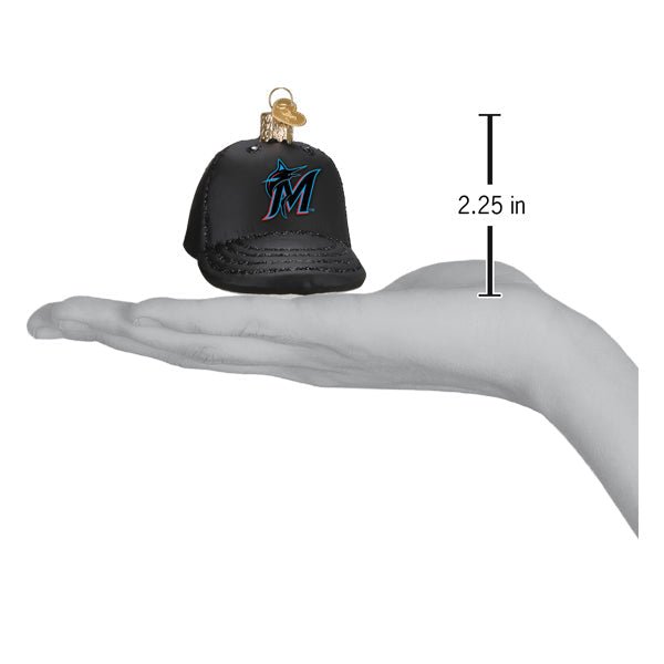 Marlins baseball cap ornament resting on an open palm beside a 2.25 inch height marker