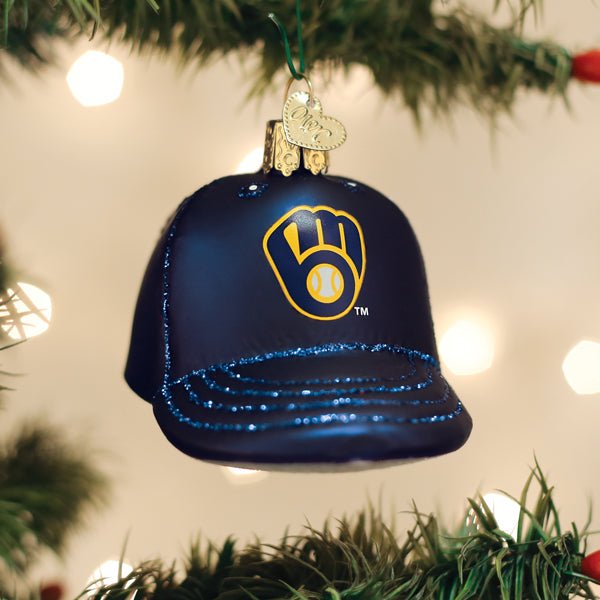 Brewers cap ornament hanging on a lit Christmas tree with warm bokeh lights behind