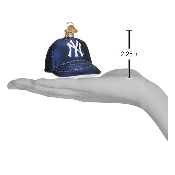 Yankees baseball cap ornament resting on an open palm beside a 2.25 inch height marker